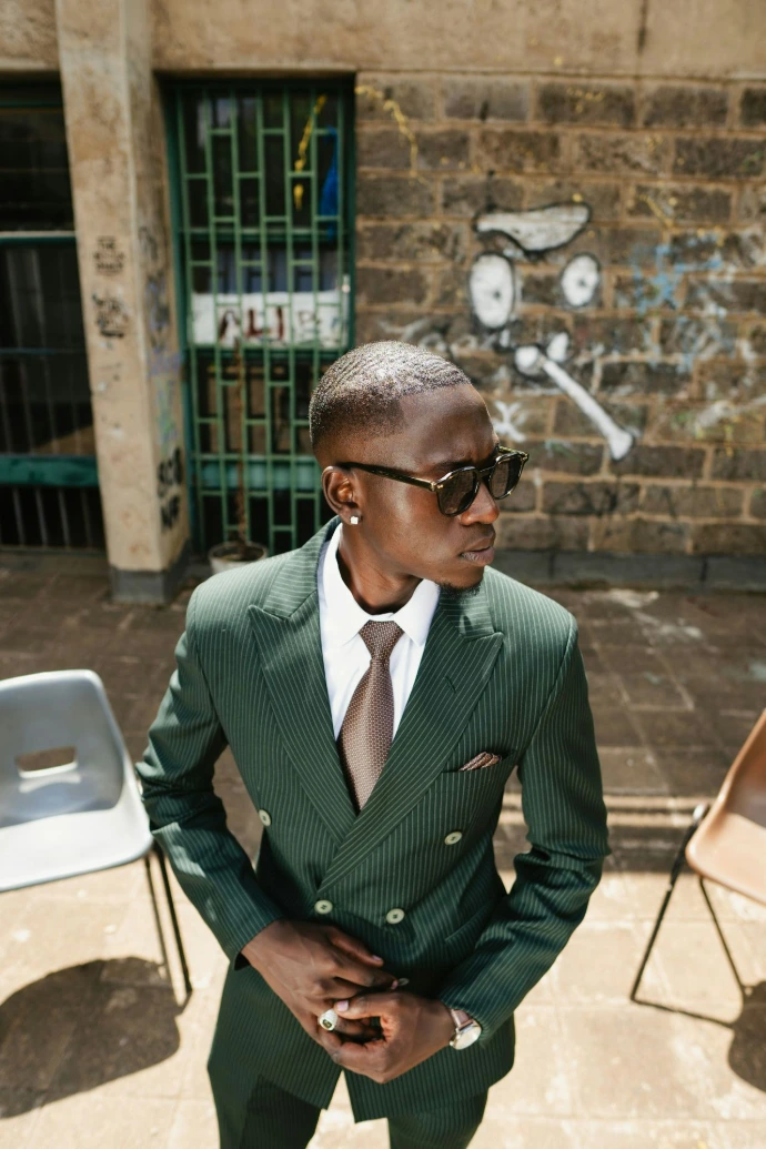 Man in a green pinstripe suit and sunglasses